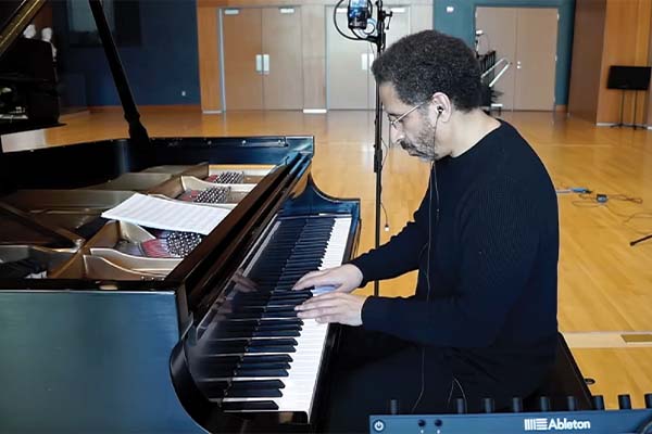 Side view of a person playing piano