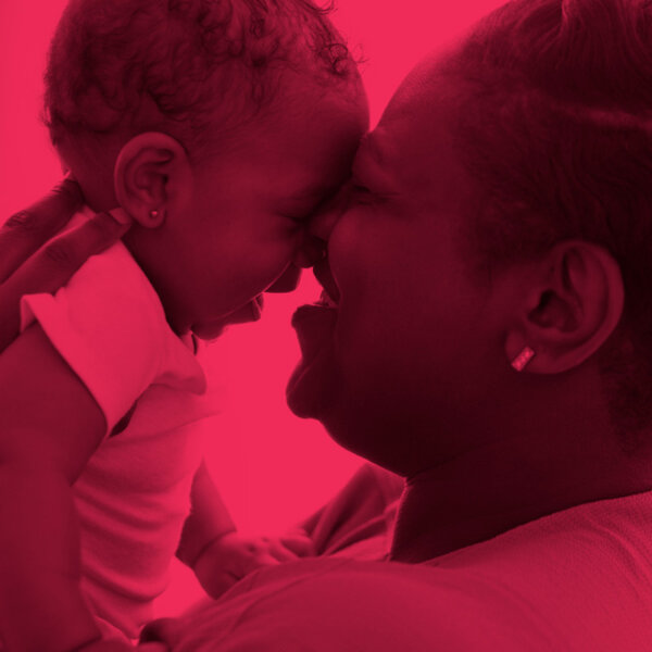 A mom holds her baby close to her face