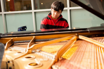 A student playing a piano