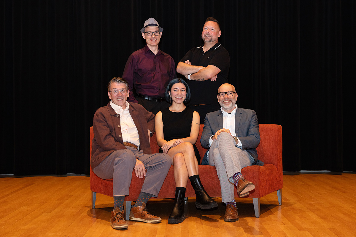 Prelude faculty sitting on a couch on a stage