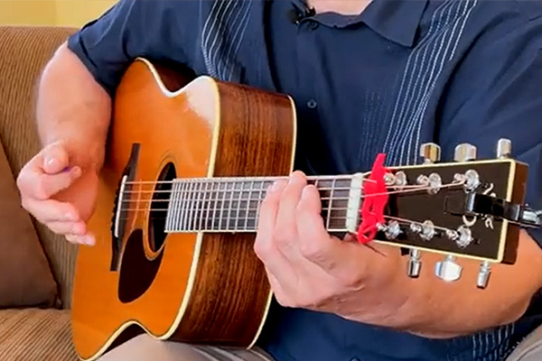 Close view of a person playing guitar