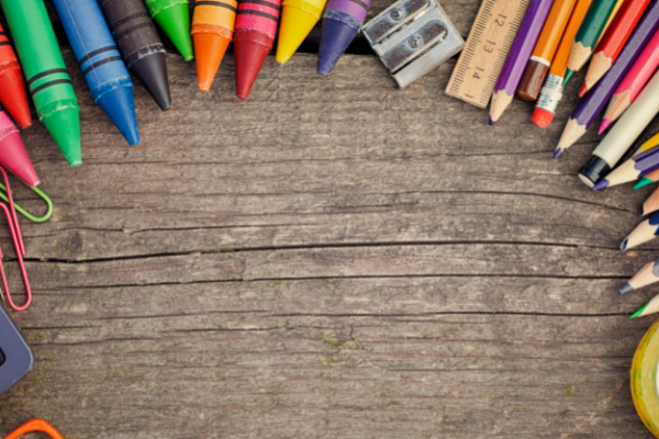 School supplies laying on a table forming an arch