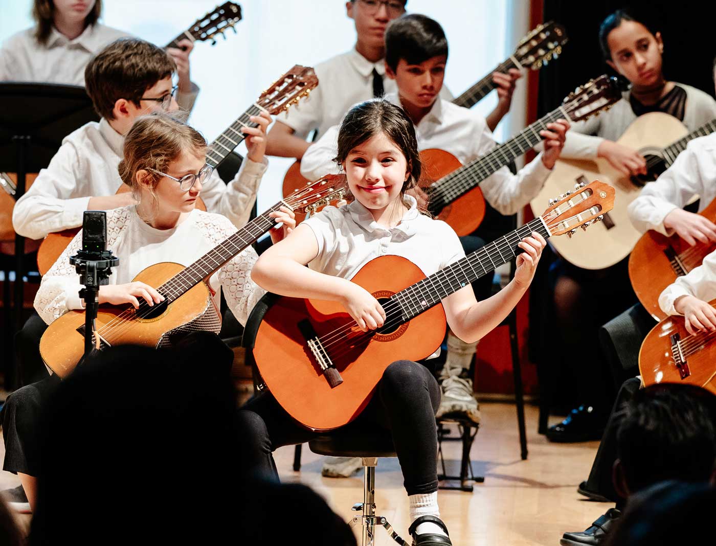 Suzuki guitar players on stage