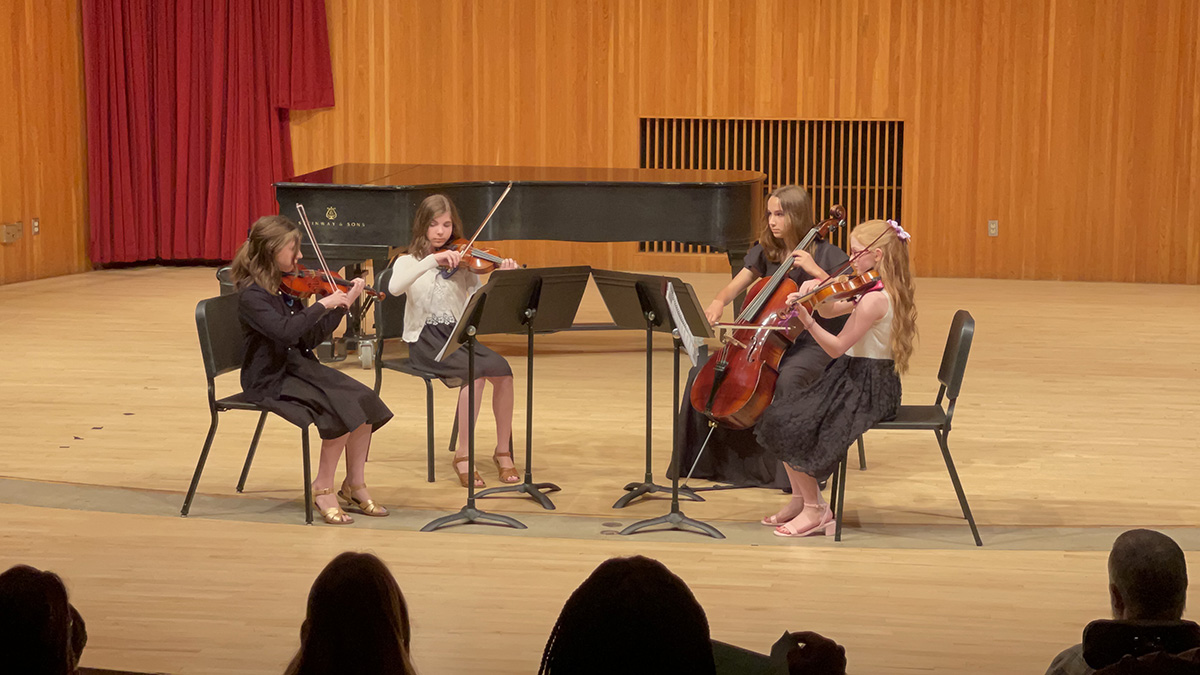 A string quartet made up of Suzuki students performing at Antonello Hall.