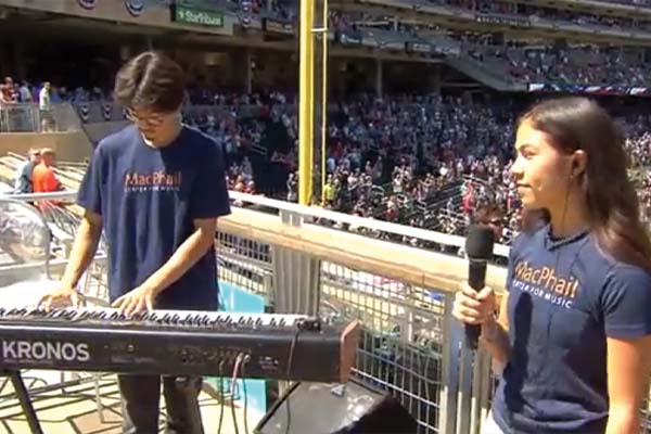 Two students performing at a baseball game