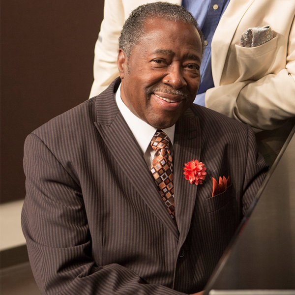 Reverend Carl sitting at a piano