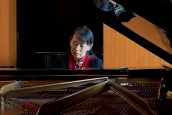 Yue Wu seated at piano