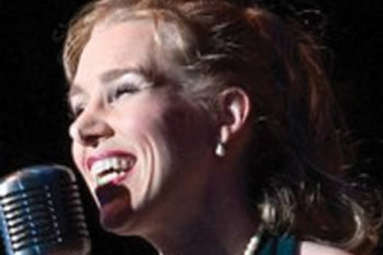 Sheridan singing into a microphone